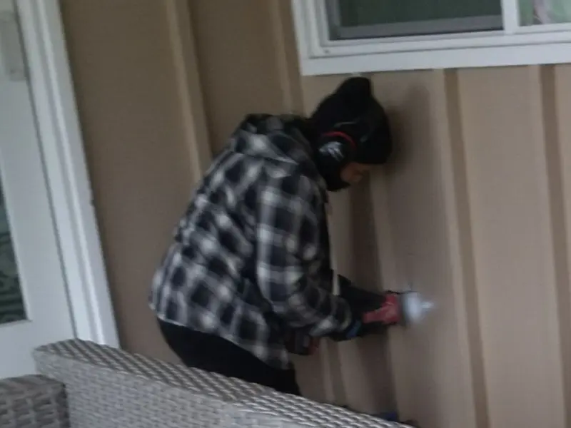 Professional electrician installing an exterior outlet in Clearview